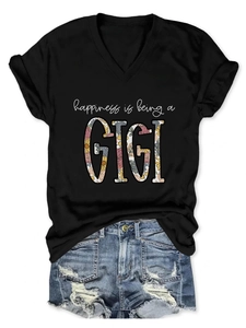 Detail of V-neck T-shirt with Happiness is Being a GIGI floral lettering and denim shorts