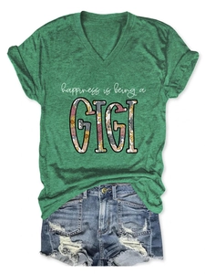 Flat lay of green V-neck T-shirt with 'happiness is being a GIGI' floral print