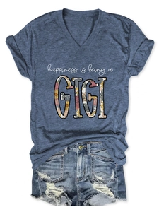 Detail of V-neck graphic t-shirt with happiness is being a GIGI text and floral print