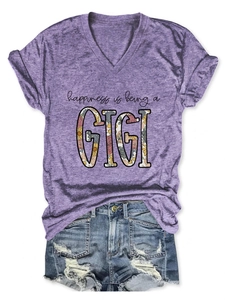 Flat lay of purple V-neck T-shirt with GIGI floral print and ripped denim shorts