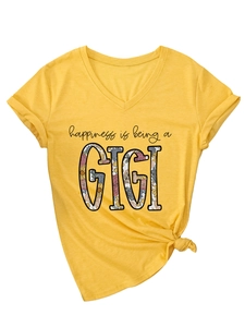 Detail of V-neck yellow t-shirt with happiness is being a GIGI text and hem knot