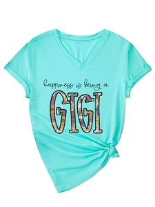 Detail of mint green V-neck T-shirt featuring floral GIGI print and stylish knotted hem