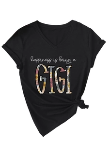 Detail of V-neck black T-shirt with GIGI floral print and stylish front knot hem