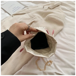 Top view of mini pearl crossbody bag interior showing black lining and drawstring closure