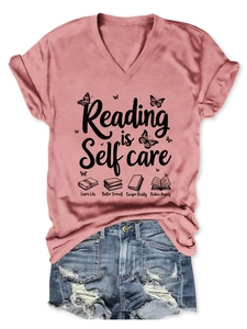 Detail of pink V-neck T-shirt with 'Reading is Self Care' print and denim shorts set