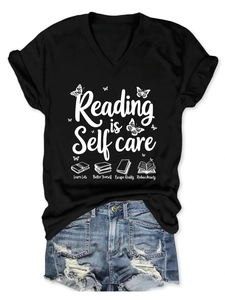 Close-up of Reading is Self Care slogan print on black V-neck cotton T-shirt