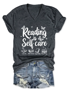 Detail of grey V-neck T-shirt with Reading is Self Care print and denim shorts
