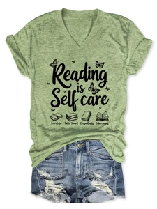 Detailed flat lay of V-neck Reading is Self care T-shirt with denim shorts set