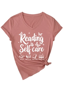 Detail of V-neck brick red T-shirt with Reading is Self Care print and soft cotton texture