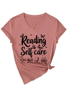 Detail of mauve pink cotton T-shirt featuring Reading is Self Care text and book graphics
