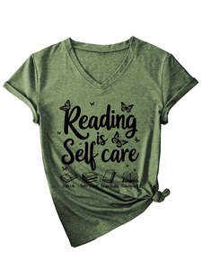 Detail of green V-neck T-shirt with Reading is Self Care text and book illustrations