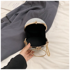 Detail of silver rhinestone evening box bag showing interior lining and round metal handle