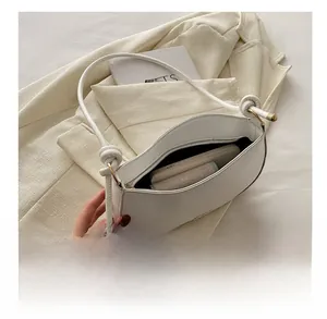 Internal view of minimalist shell bag showing space for phone and wallet with zipper