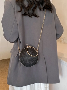 Sparkly black spherical evening clutch bag with gold chain and metal ring handles