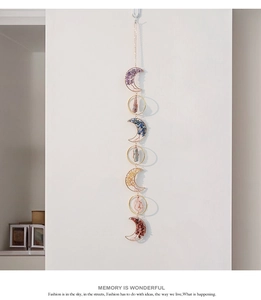 Detail of bohemian suncatcher featuring seven moon and circle frames with natural crystals