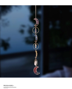 Macro detail of natural crystal suncatcher showing amethyst and wire wrapping