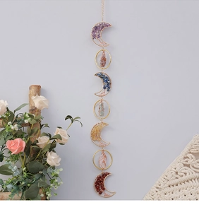 Detail of amethyst crystal suncatcher with Tree of Life wire weave on crescent moon charms