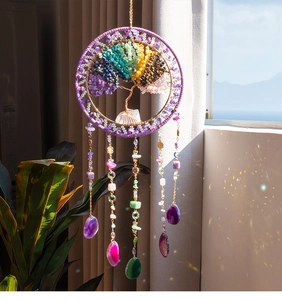 Macro shot of colorful stone Tree of Life suncatcher with light reflecting on crystals
