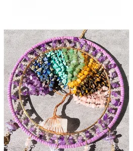 Macro shot of handmade copper tree of life pendant with colorful natural stone chips