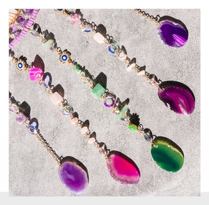 Close-up of suncatcher detail with agate slices, amethyst, and blue evil eye beads
