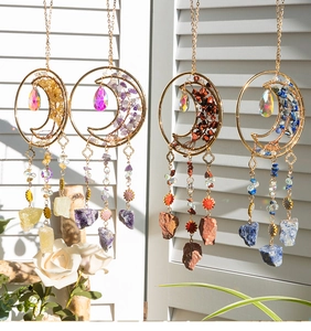 Detail of four handmade moon dreamcatchers with natural crystals and gold metal rings