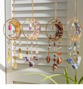 Detail of moon suncatchers with natural agate crystals and iridescent glass prisms