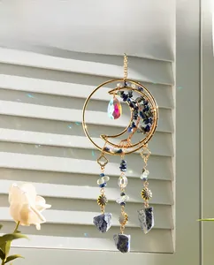 Detailed close-up of crescent moon dream catcher with blue stones and crystal teardrop
