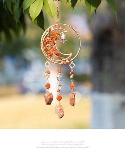 Detailed view of Tree of Life suncatcher with red agate stones and crystal prism pendant