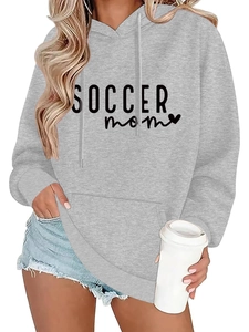 Close-up of Soccer Mom hoodie with heart graphic and casual denim shorts outfit