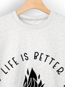 Close-up of Life Is Better lettering and flame print on grey crewneck sweatshirt