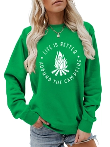 Detail of green crewneck sweatshirt showing white campfire print and ribbed cuff texture