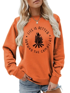 Detail of orange crewneck sweatshirt with bonfire print and ribbed cuffs and hemline
