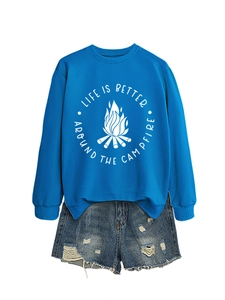 Detail of blue campfire sweatshirt paired with distressed denim shorts for a casual look
