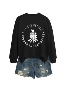 Detail of campfire print on black crewneck sweatshirt paired with distressed denim shorts