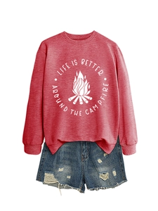 Flat lay of red sweatshirt with campfire slogan and distressed blue denim shorts