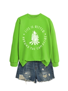 Detail of neon green sweatshirt featuring campfire graphics and Life Is Better quote