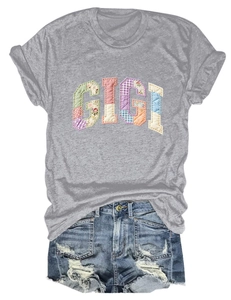 Flat lay of gray T-shirt with GIGI patchwork lettering and ripped blue denim shorts