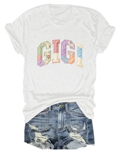 Detail of GIGI patchwork embroidery on a white cotton T-shirt with denim shorts