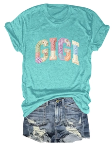 Detailed view of Gigi rainbow patchwork on mint green T-shirt and denim shorts