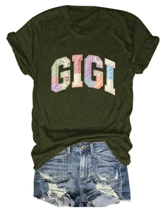 Detail of GIGI patchwork letters on olive green t-shirt with distressed denim shorts