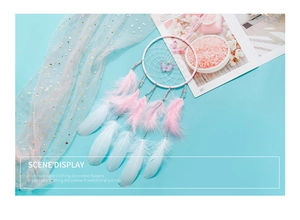 Detail of handmade dream catcher with pastel feathers, beads and butterfly ornaments
