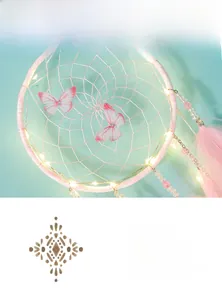 Close-up of pink dream catcher with glowing LED lights, butterflies and soft feathers
