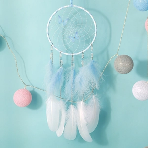 Blue and white dream catcher with feathers, butterfly charms, and warm LED lights
