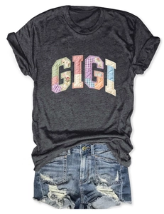 Flat lay of Gigi patchwork T-shirt paired with distressed denim shorts on white background