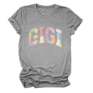 Detailed close-up of colorful floral patchwork GIGI lettering on grey cotton T-shirt