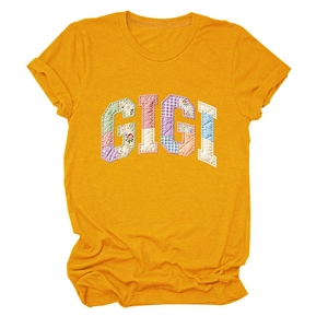 Detail of GIGI applique lettering on yellow round neck cotton T-shirt with rolled sleeves
