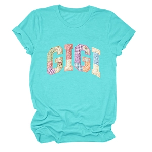 Detail of GIGI patchwork applique on a soft turquoise short sleeve cotton t-shirt