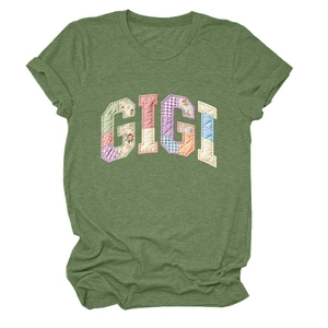 Detail of GIGI patchwork applique with floral and plaid patterns on green cotton T-shirt