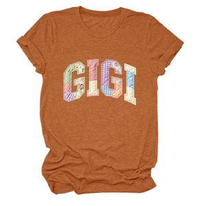 Close-up of Gigi patchwork letters on a rust orange crew neck cotton T-shirt