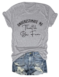 Detailed flat lay of a grey crewneck t-shirt with Underestimate Me slogan and denim shorts
